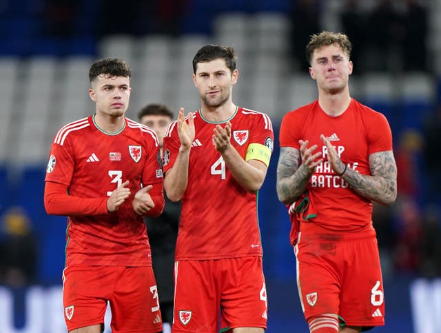 <p>Wales captain Ben Davies applauds fans alongside his teammates</p>